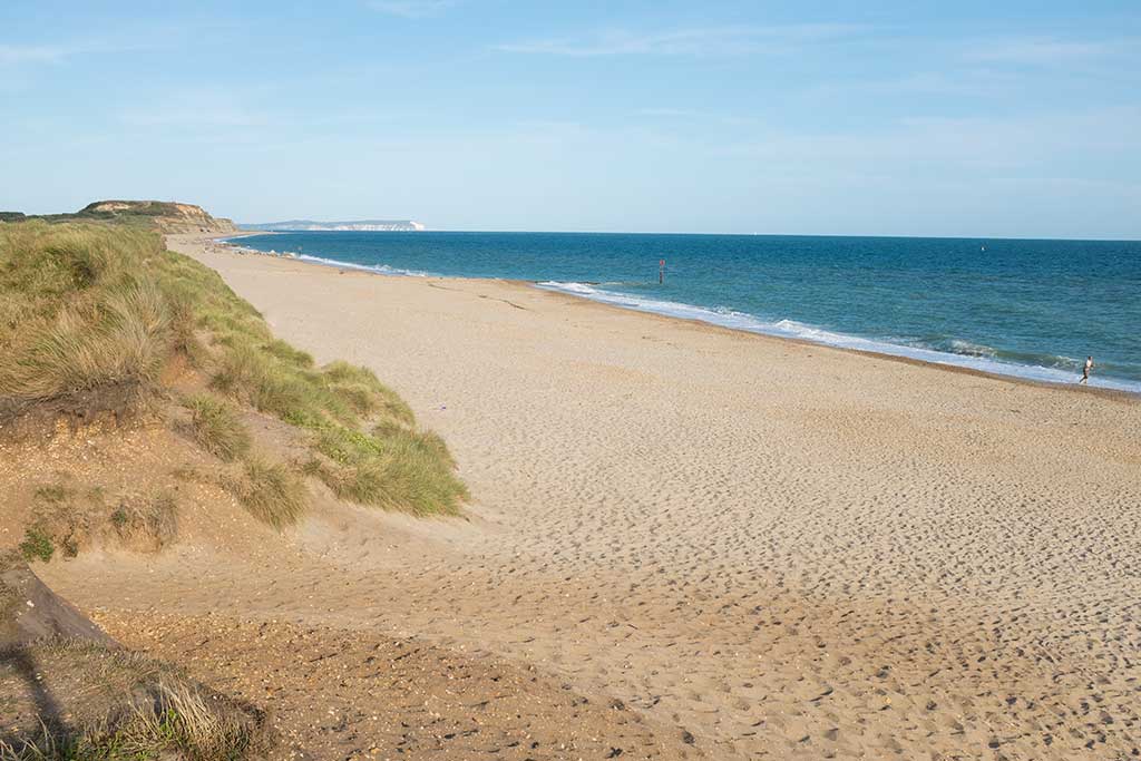 Hengistbury Head Beach looking east with views of the Isle of Wight in the background.