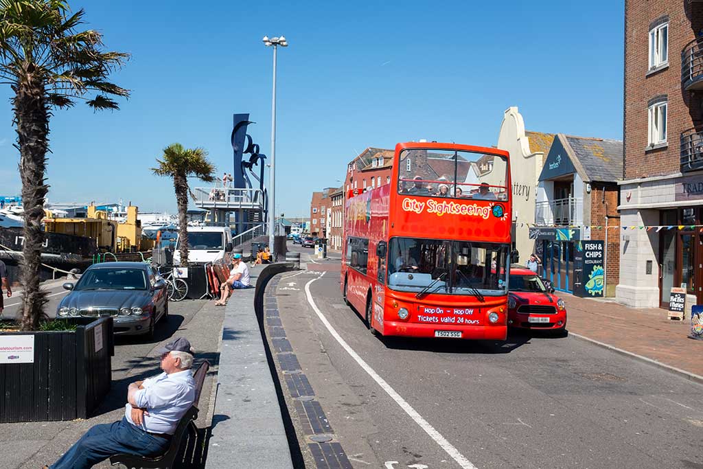 Bournemouth City Sightseeing Bus driving along Poole Quay