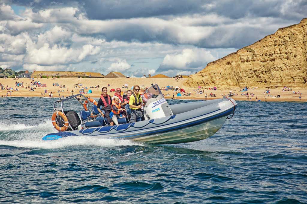 RIB boat with West Bay in the background